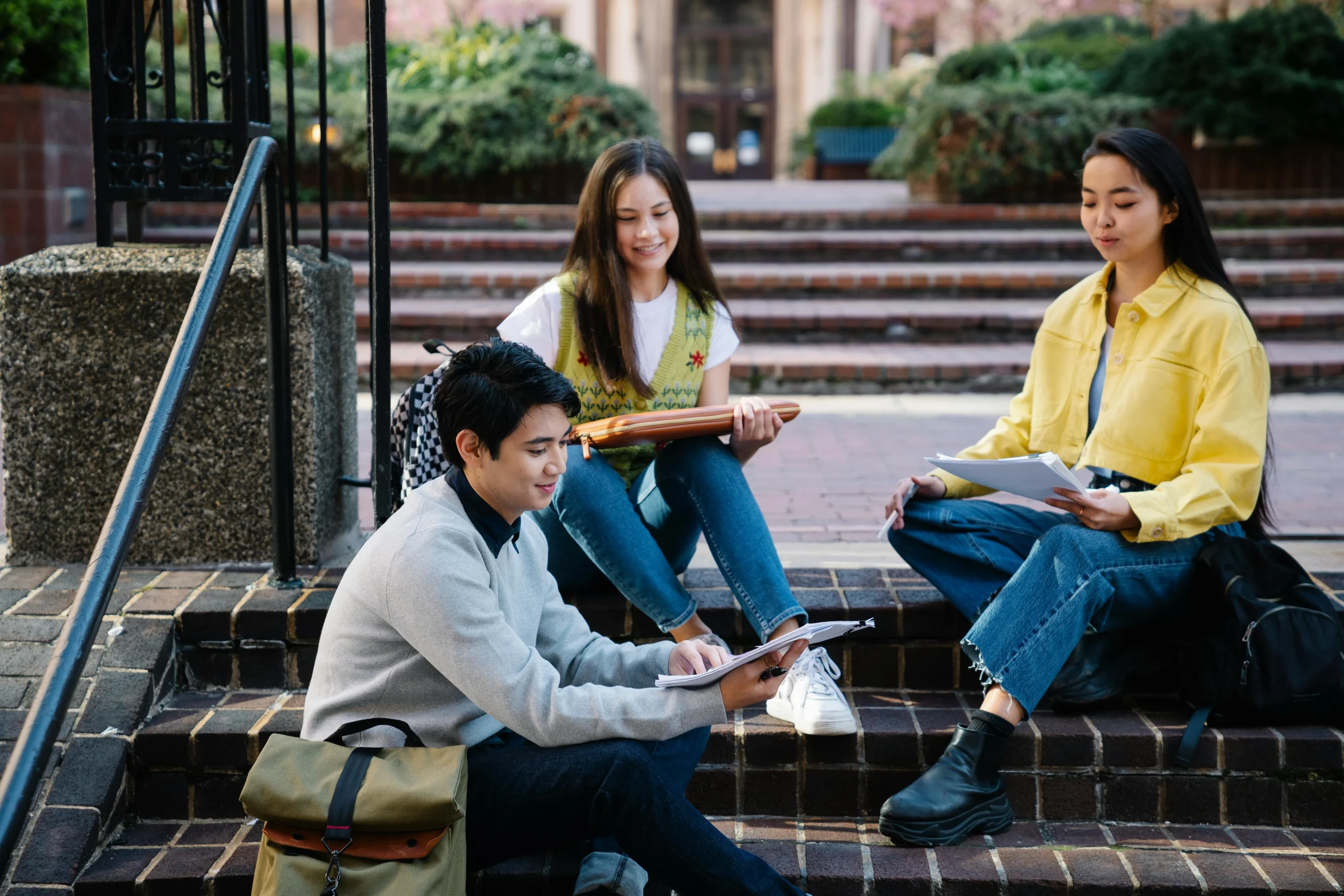 college students sitting on stairs and talking.