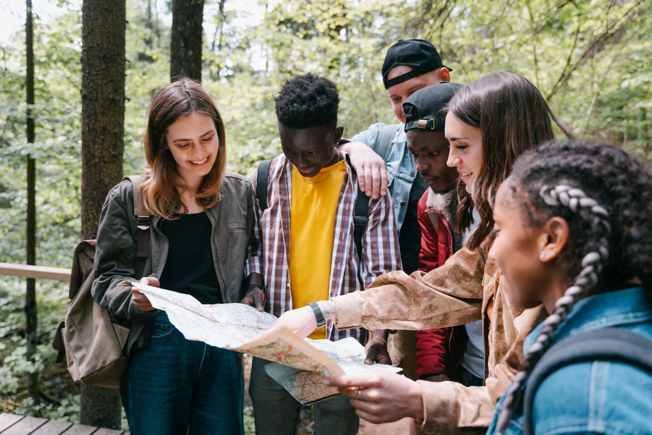 a group of people looking over a guide.