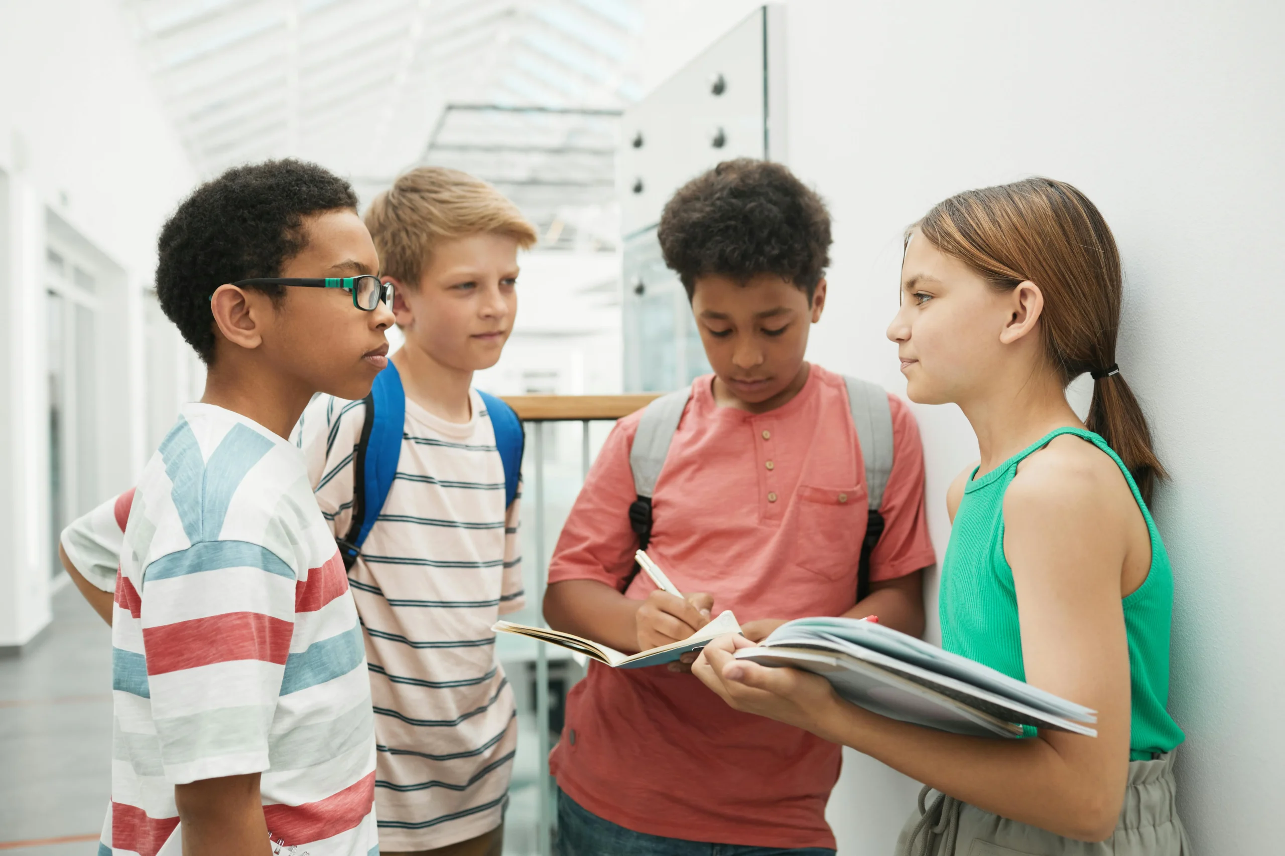 a group of students talking in the hallway.