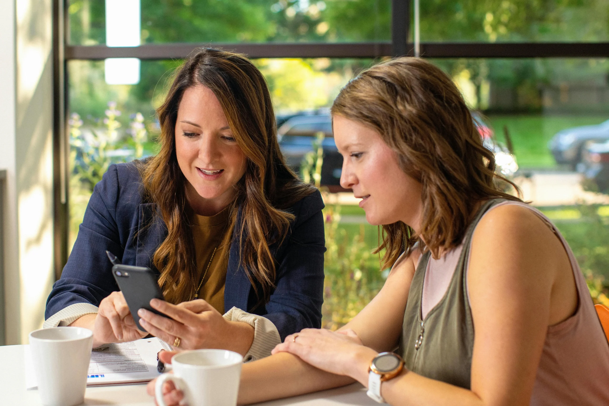 an image of a woman and young lady talking.