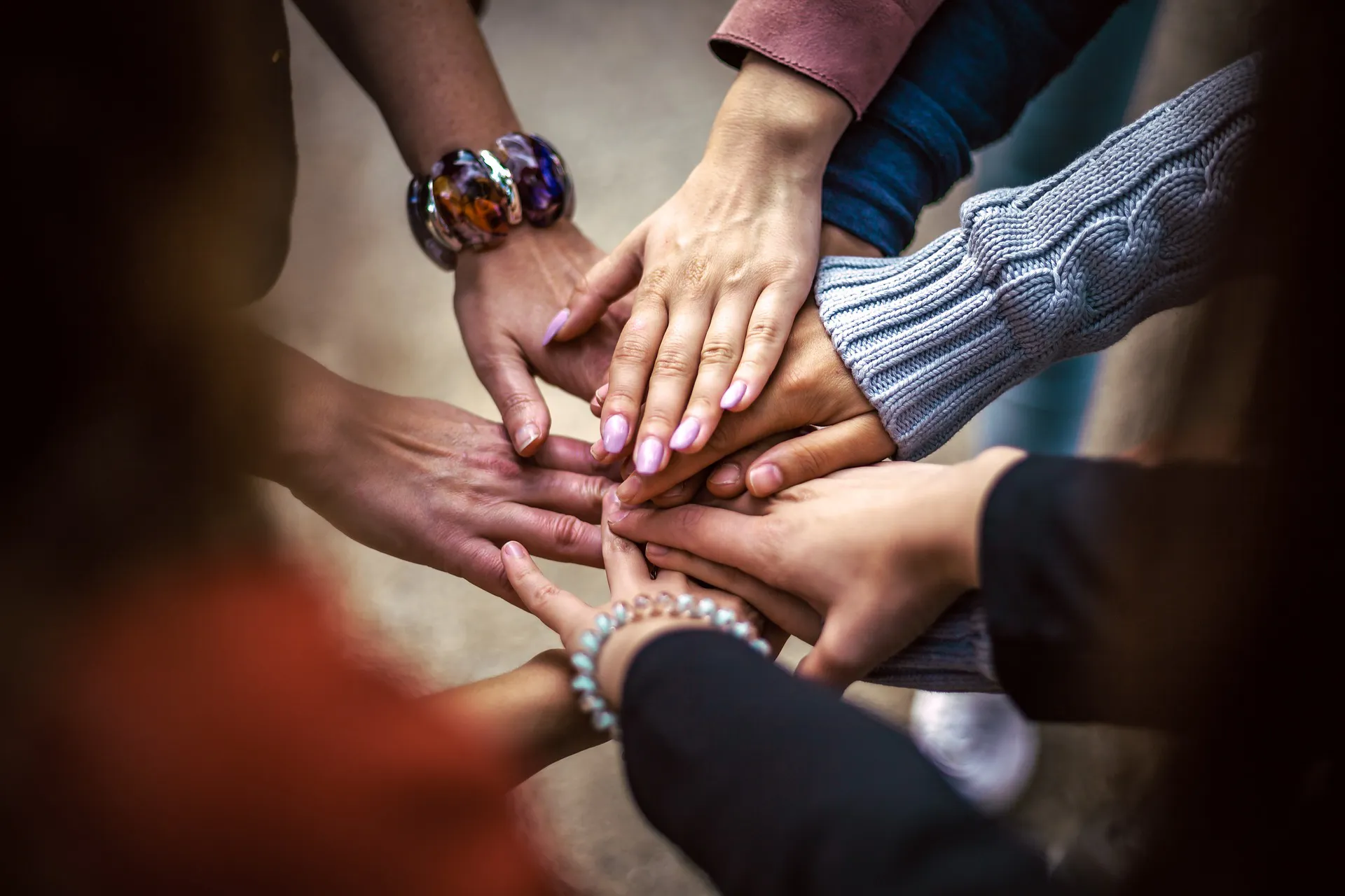a photo of a group of volunteer hands together.